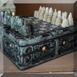 D04. Carved stone miniature chess set.